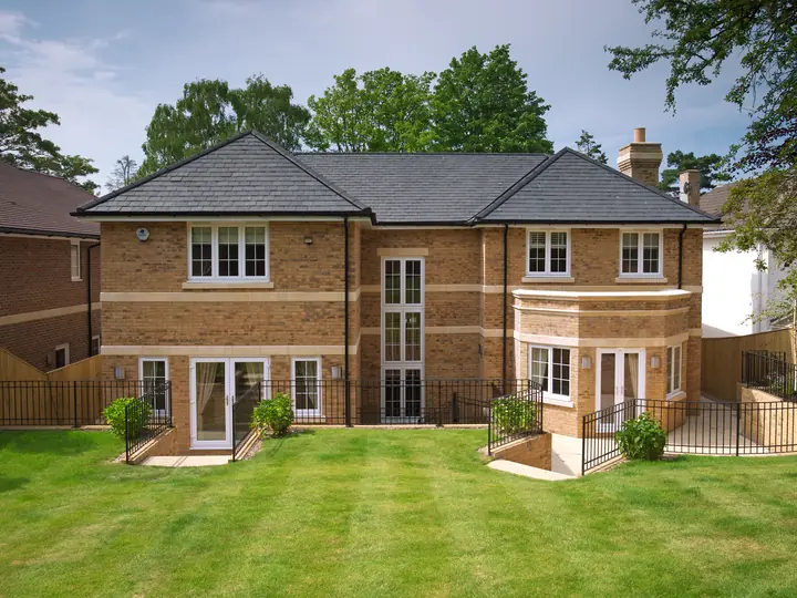 Brick house with a new grey tiled roof