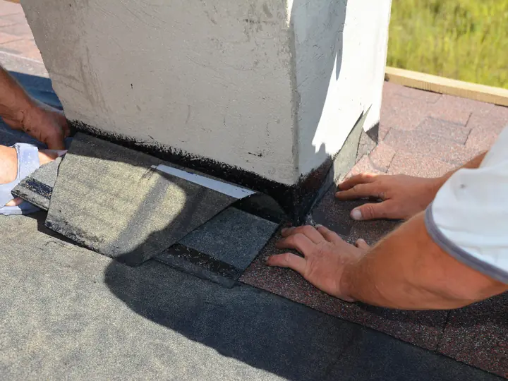 Lead flashing being fitted round a chimney