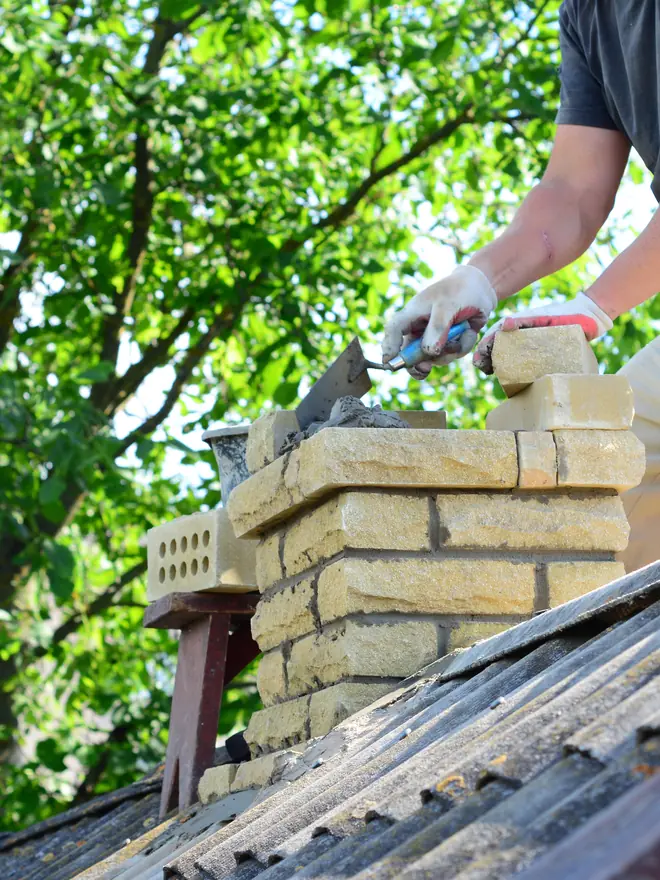 Roofer working on a chimney stack