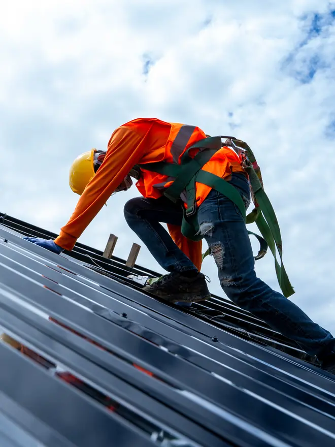 Roofer working on a metal commercial roof