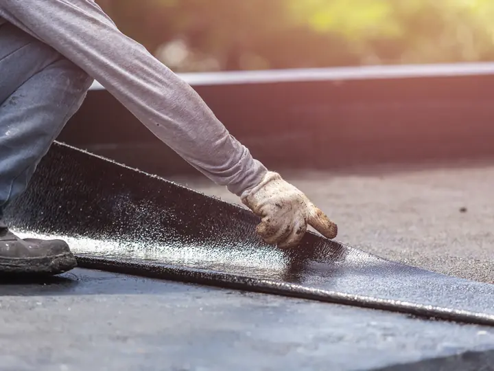 Felt being sealed along a flat roof edge