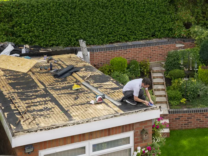 Garage roof seen from above with the old covering stripped for new decking