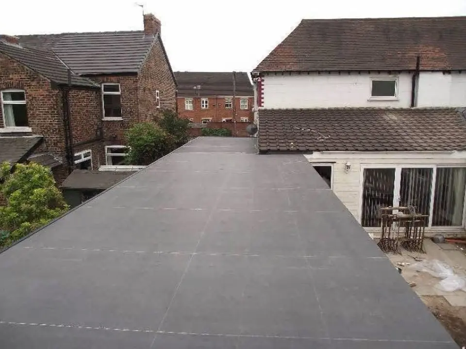 New flat roof running the length of a rear garage and extension