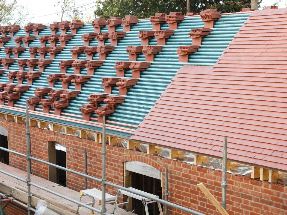 Re-roof in progress with new tiles and membrane