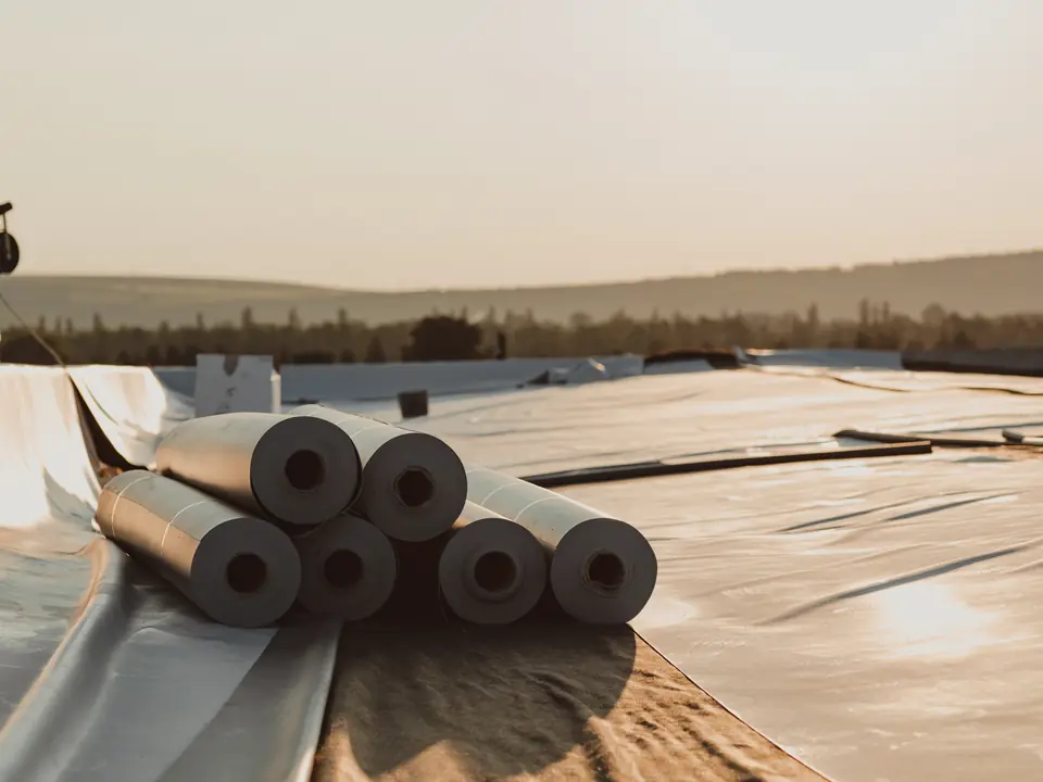 Rolls of rubber membrane on a flat roof