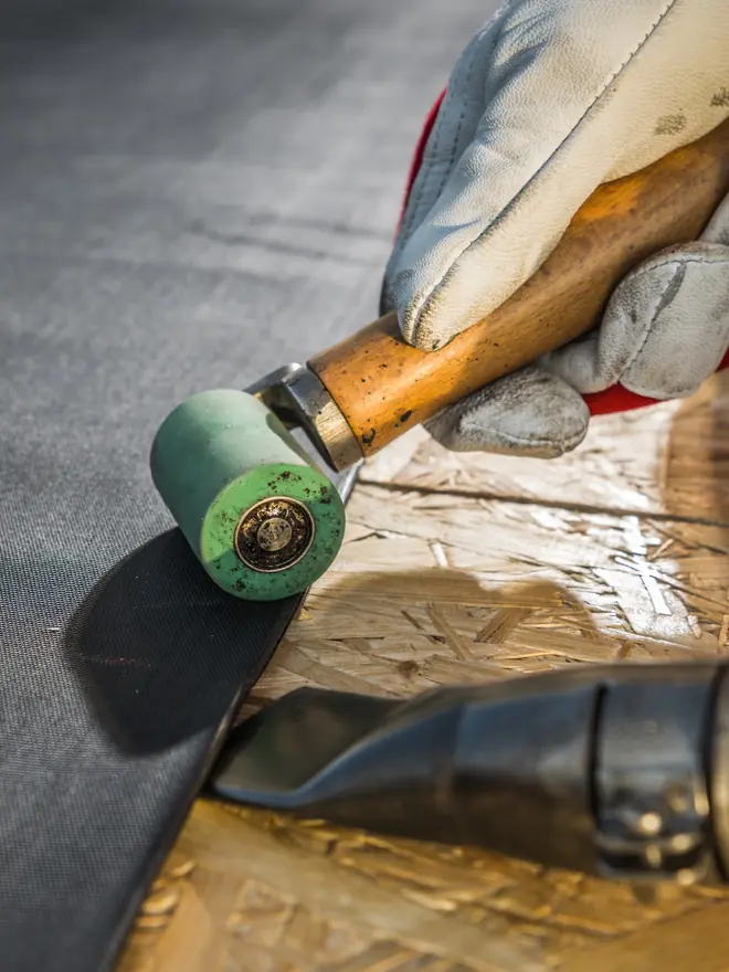 Roofer sealing a rubber roof joint