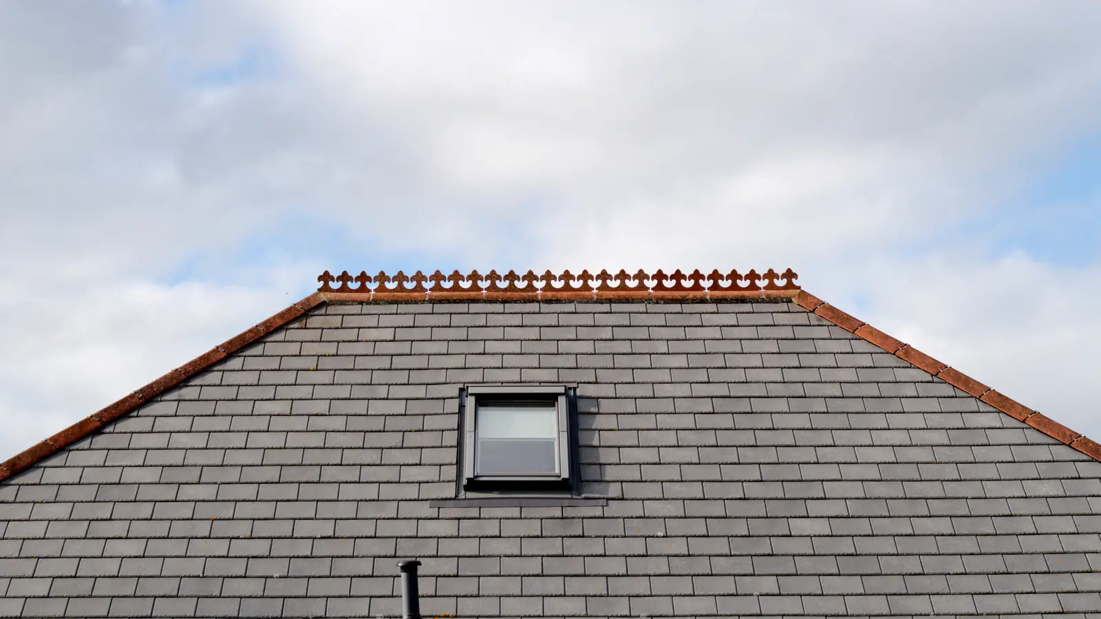 Grey slate roof with a roof window