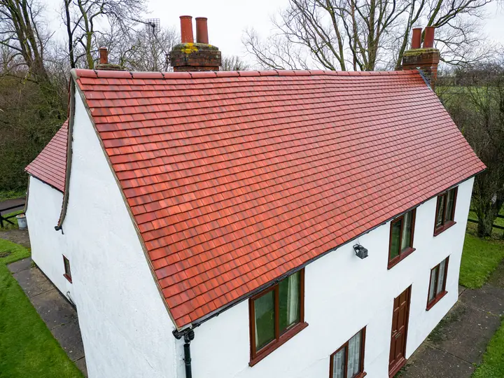 Cottage with a red plain tile roof