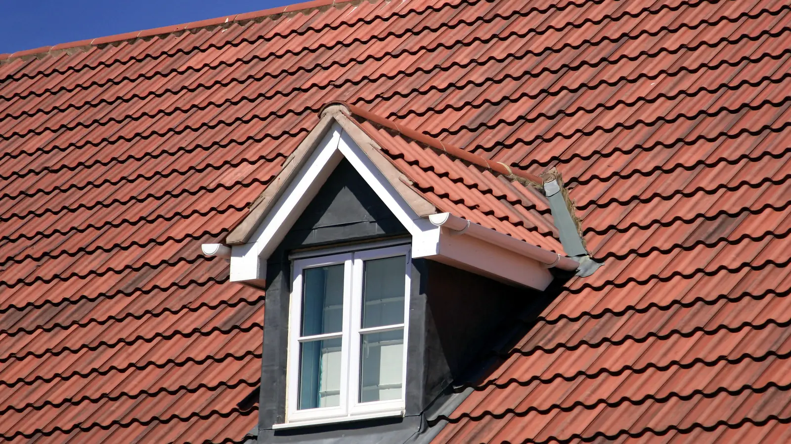 Red clay tile roof with a tiled dormer window
